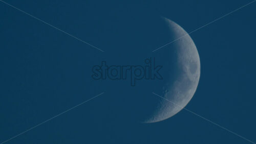 Video - Close up of crescent moon illuminated against a deep blue sky