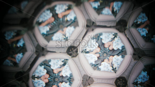 Video - A creative kaleidoscope effect featuring multiple mirrored images of sleeping babies wrapped in blankets