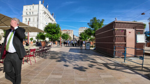 Video - Cannes, France - September 20, 2025: Lively pedestrian street with outdoor cafes, colourful chairs, and people enjoying the sunny day on the French Riviera