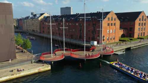 Video – Copenhagen, Denmark – August 7, 2025: Aerial drone view of the Circle Bridge across Copenhagen’s Christianshavn canal with cyclists and boats - Starpik Stock