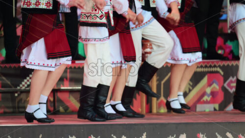 Video – Traditional folk dancers performing traditional step dance on stage, celebrating their culture through traditional movements. Wearing vibrant Moldavian costumes - Starpik Stock