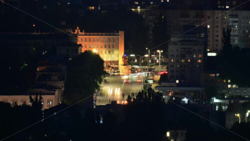 Video - Timelapse of cars riding at night in city center. Telephoto perspective. Chisinau, Moldova