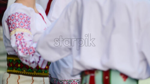 Video - Dancers in traditional Moldavian and Romanian attire perform lively folk dances, displaying colorful costumes and elegant movements