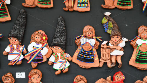 Video - Colorful traditional Romanian and Moldavian clay figurines in national clothes are displayed on a local artisan handmade pottery market.