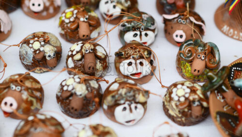 Video - Creative traditional sheep figurines on display at local craft fair in a vibrant market setting. Moldavian and Romanian pottery