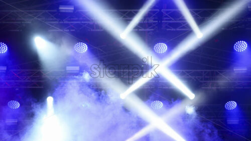 Video - Colorful lights and smoke create an exciting atmosphere at an outdoor music festival. Slow motion shot of stage lighting