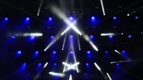Video - Colorful lights illuminate the stage during an exciting music event in a vibrant setting. Slow motion