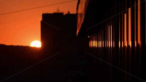 Video - Sunset view over the city skyline reflecting vibrant colors during evening hours
