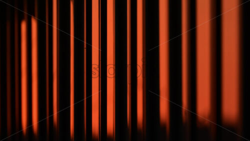 Video - Unique vertical lines creating beautiful orange patterns in urban light during sunset. window reflection