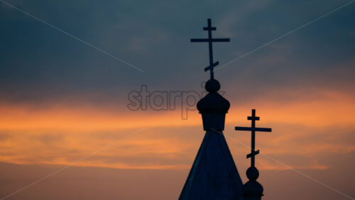 Video - Silhouette of a church at sunset, epicsky with warm hues of orange and purple
