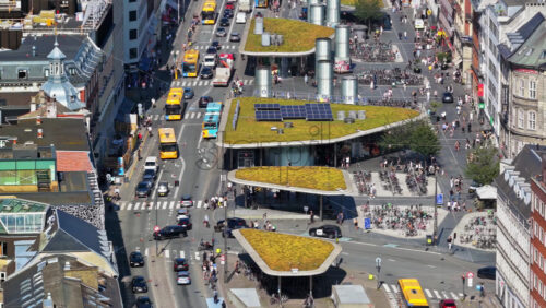 Video - Copenhagen, Denmark - August 6, 2025:Aerial drone view of city traffic, cyclists, and modern green-roofed bike pavilions at Norreport Station