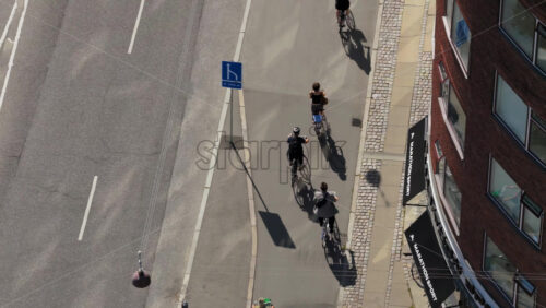 Video - Copenhagen, Denmark - August 6, 2025: Aerial drone view of cyclists filling Copenhagen's bike lanes during a busy day