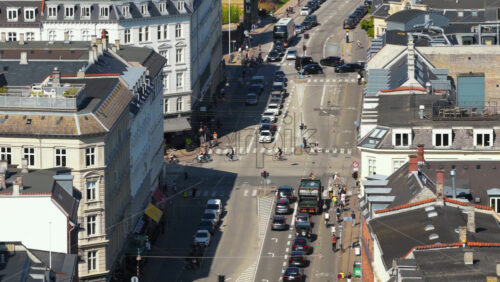 Video - Copenhagen, Denmark - August 6, 2025: Aerial drone view of cars, buses, and bicycles navigating through heavy traffic during rush hour