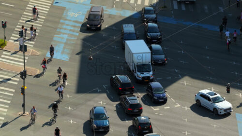 Video - Copenhagen, Denmark - August 6, 2025: Aerial drone view of a bustling intersection showing cars, buses, cyclists passing through the city center