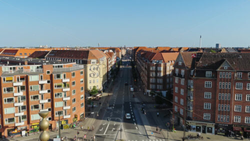 Video - Copenhagen, Denmark - August 6, 2025: Aerial drone view over Peblinge So lake in Copenhagen, Denmark, with traffic moving along Gyldenlovesgade