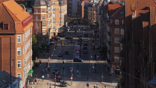 Video - Copenhagen, Denmark - August 6, 2025: Aerial drone view of Norrebrogade with cars, cyclists, and pedestrians crossing a busy intersection