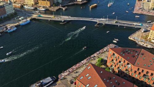 Video - Copenhagen, Denmark - August 6, 2025: Aerial drone view of the Copenhagen harbor with the Inderhavnsbroen bridge, the Marble Church dome, and the Royal Danish Playhouse
