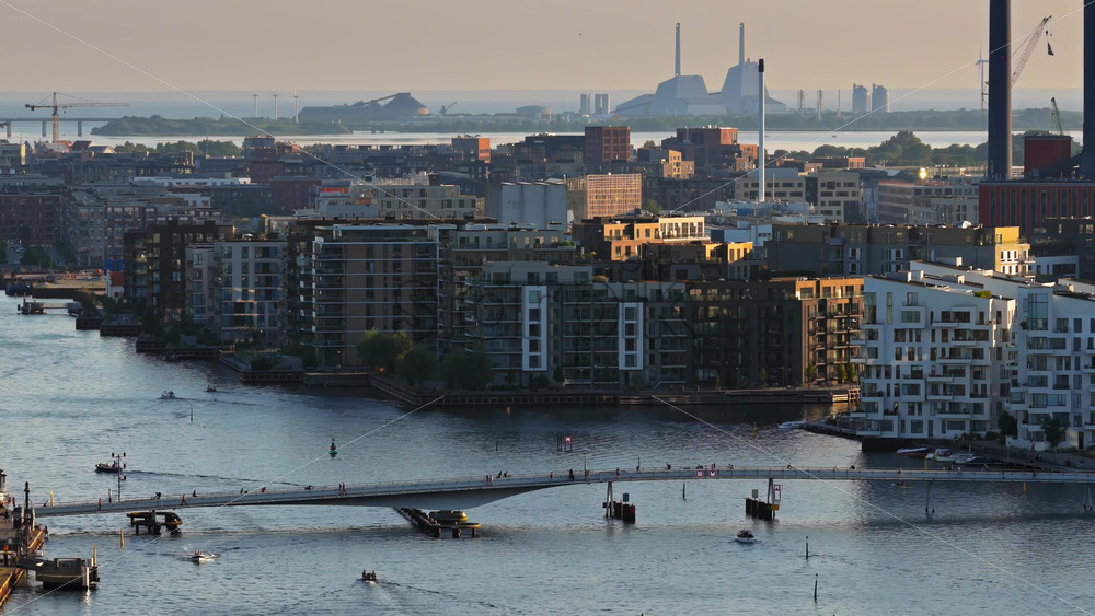Video - Aerial drone view of the modern harborfront district with apartments and the Kalvebod Wave bridge, Copenhagen, Denmark