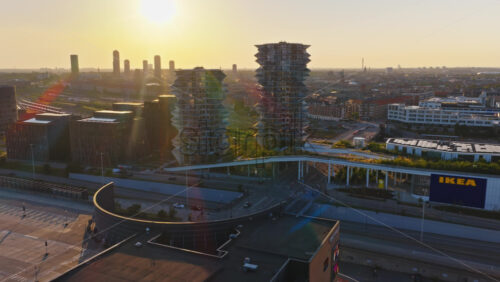 Video - Copenhagen, Denmark - August 6, 2025: Aerial drone view of the Cactus Towers with futuristic balconies, captured at sunset above the cityscape