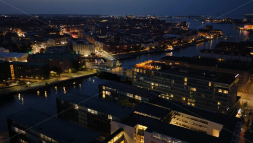 Video - Aerial drone view of Vesterbro's skyline, in Copenhagen, Denmark, at night