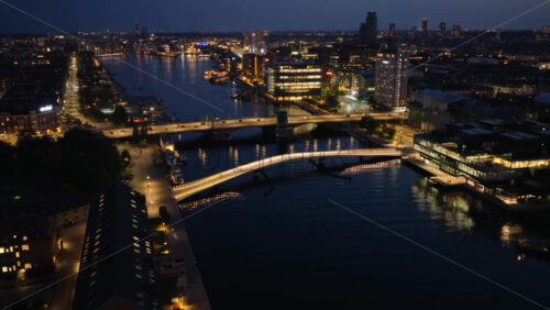 Video - Aerial drone view of Langebro Bridge connecting Christianshavn to the city center, with Copenhagen's illuminated skyline beyond