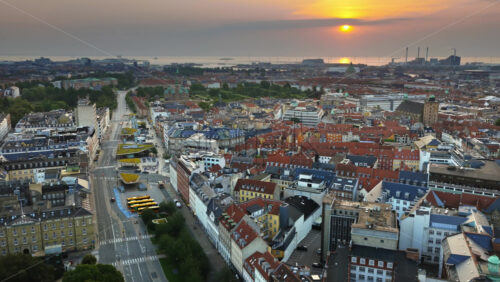 Video - Copenhagen, Denmark - August 7, 2025:Aerial drone view of city traffic, cyclists, and modern green-roofed bike pavilions at Norreport Station