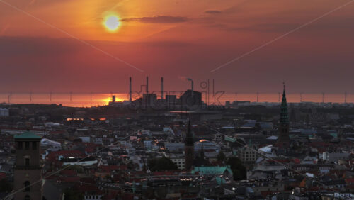 Video - Aerial drone view of the skyline of Copenhagen, Denmark with Amager Bakke and offshore wind turbines at sunrise