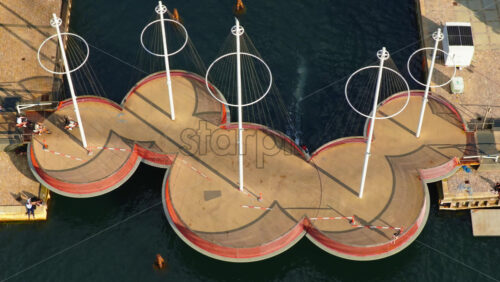 Video - Copenhagen, Denmark - August 7, 2025: Aerial drone view of the Circle Bridge with people crossing and boats below