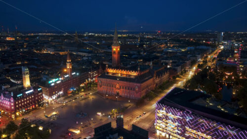 Video - Copenhagen, Denmark - August 8, 2025: Aerial drone time lapse of city lights with car traffic, bridges, and illuminated streets across the city in the evening