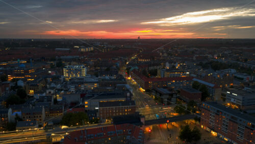 Video - Aerial drone time lapse of city lights with car traffic, bridges, and illuminated streets across the city at sunset