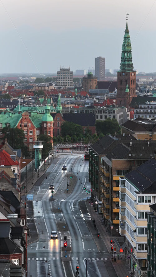 Video - Aerial drone view of central Copenhagen with spire of St. Nicholas Church at sunrise, Denmark. Vertical