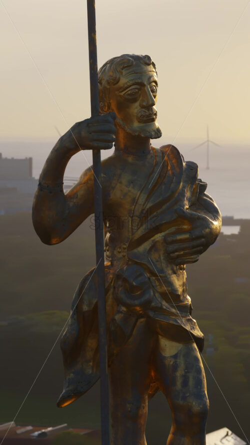 Video - Aerial drone view of the golden statue atop a sphere on the Church of Our Saviour overlooking the Copenhagen skyline, with Frederik's Church dome in the background in Denmark. Vertical