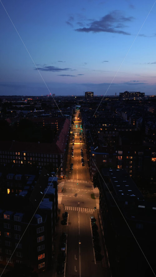 Video - Aerial drone view of the city center of Copenhagen, Denmark at night. Vertical