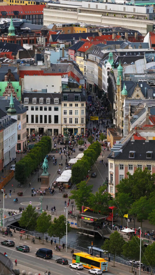 Video - Copenhagen, Denmark - August 5, 2025: Aerial drone view of Stroget, Europe's longest pedestrian shopping street, filled with people and historic architecture. Vertical