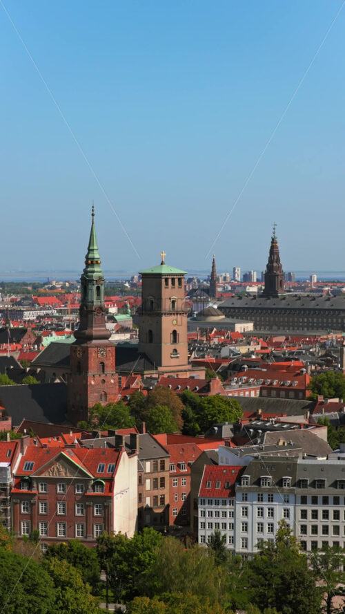Video - Aerial drone view of St. Peter's Church and Copenhagen skyline at sunrise, Denmark. Vertical