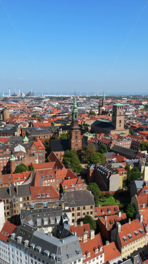 Video - Aerial drone view of St. Peter's Church and Copenhagen skyline at sunrise, Denmark. Vertical