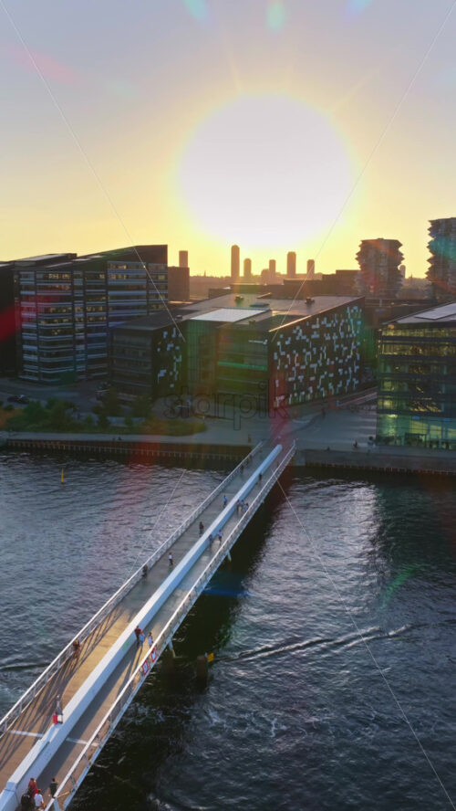 Video - Copenhagen, Denmark - August 6, 2025: Aerial drone view of the Cactus Towers with futuristic balconies, captured at sunset above the cityscape. Vertical