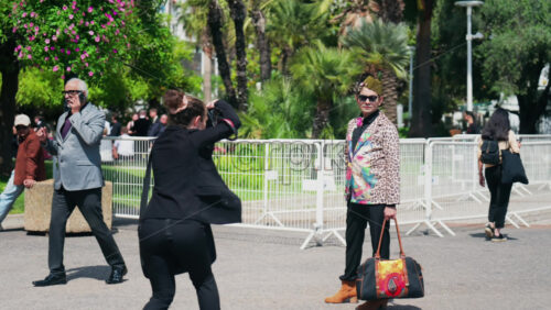 Video - Cannes, France - May 13, 2025: Fashionable man posing on the street in daylight