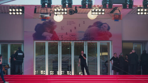Video - Cannes, France - May 13, 2025: The entrance at Cannes Film Festival with a red carpet, security and event crew