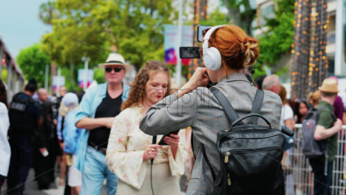 Video - Cannes, France - May 13, 2025: Woman talking on the microphone in front of a camera at the Cannes Film Festival