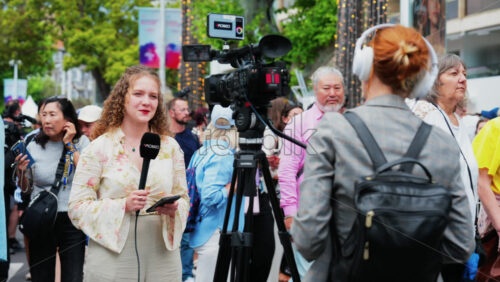 Video - Cannes, France - May 13, 2025: Woman talking on the microphone in front of a camera at the Cannes Film Festival