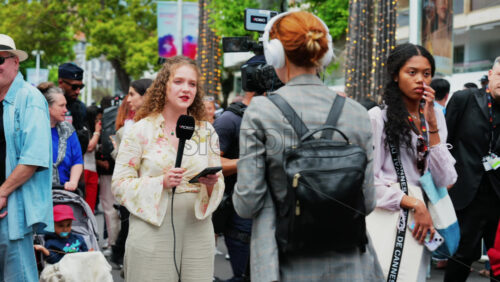 Video - Cannes, France - May 13, 2025: Woman talking on the microphone in front of a camera at the Cannes Film Festival