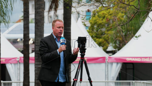Video - Cannes, France - May 13, 2025: Man talking on the microphone in front of a camera at the Cannes Film Festival