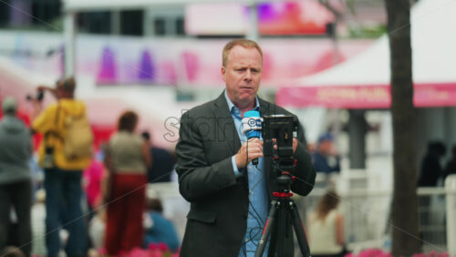 Video - Cannes, France - May 13, 2025: Man talking on the microphone in front of a camera at the Cannes Film Festival