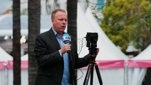 Video - Cannes, France - May 13, 2025: Man talking on the microphone in front of a camera at the Cannes Film Festival
