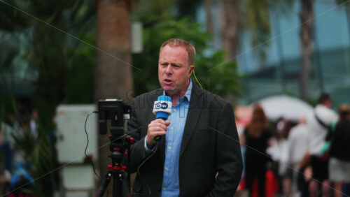 Video - Cannes, France - May 13, 2025: Man talking on the microphone in front of a camera at the Cannes Film Festival