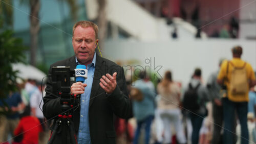 Video - Cannes, France - May 13, 2025: Man talking on the microphone in front of a camera at the Cannes Film Festival