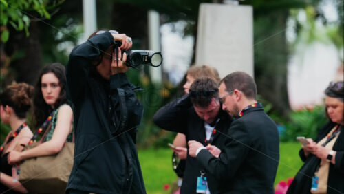 Video - Cannes, France - May 13, 2025: People taking pictures in the Palace of Festivals gardens at the Cannes Film Festival