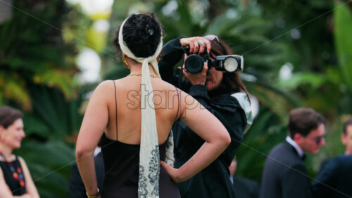 Video - Cannes, France - May 13, 2025: People taking pictures in the Palace of Festivals gardens at the Cannes Film Festival