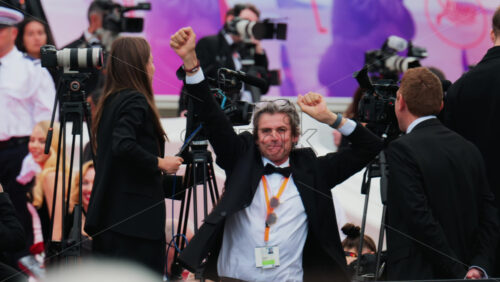 Video - Cannes, France - May 13, 2025: Man from the crew dancing at the Cannes Film Festival